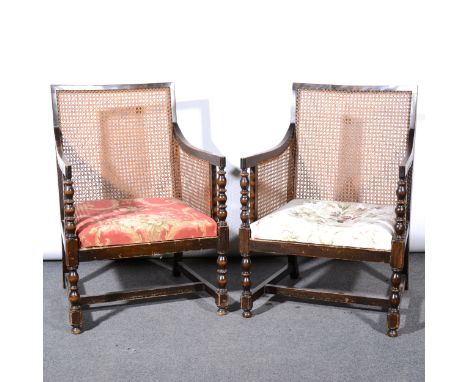 Pair of stained wood bergere library chairs, caned panelled backs and arms, drop-in seats, cotton print upholstery, bobbin-tu