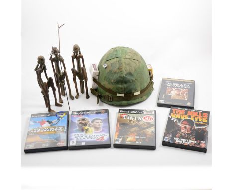 A replica US Army helmet, after the film Full Metal Jacket, and other items, carved tribal figures, various DVDs and PlayStat