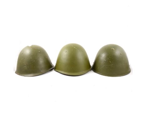 Three Russian army steel helmets.