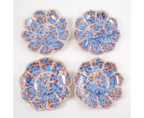 Four Imari shallow bowls, lotus leaf shape, decorated in blue and iron red, 23cm diam.