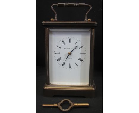 MATTHEW NORMAN OF LONDON 8 DAY BRASS FRAMED CARRIAGE CLOCK, having beveled glass panels, 11 jewel movement, no. 1752, with a 