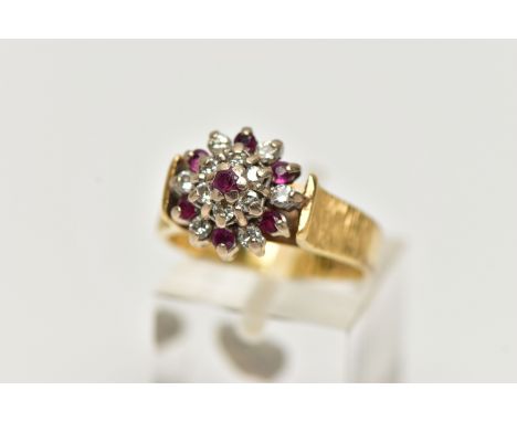 AN 18CT GOLD RUBY AND DIAMOND CLUSTER RING, designed as a tiered cluster set throughout with circular cut rubies and round br