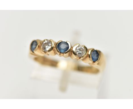 A 9CT YELLOW GOLD, DIAMOND AND SAPPHIRE HALF ETERNITY RING, designed with a row of three circular cut, light blue sapphires, 