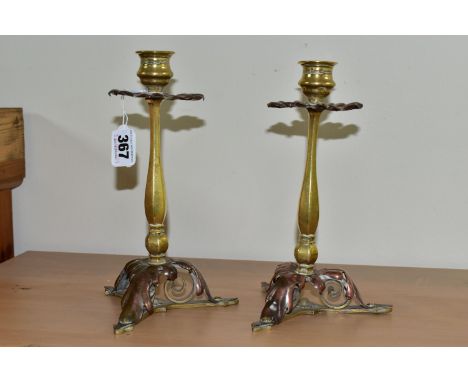 A PAIR OF BRASS AND COPPER CANDLESTICKS, in the form of flowers with foliate scrolling bases height 21.5cm (2) (Condition Rep
