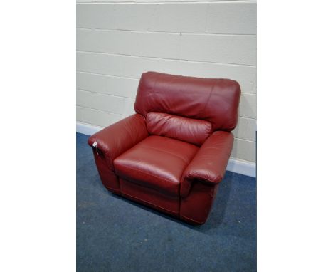 A RED LEATHER MANUAL RECLINING ARMCHAIR