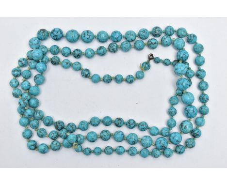 A LONG SINGLE STRAND OF TURQUIOSE BEADS, graduated circular beads each individually knotted to a string, largest measuring ap