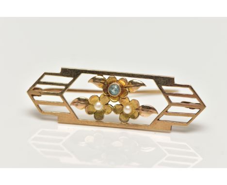 AN EARLY 20TH CENTURY GOLD BROOCH, open work brooch with floral detail, set with two seed pearls and a light blue topaz, fitt