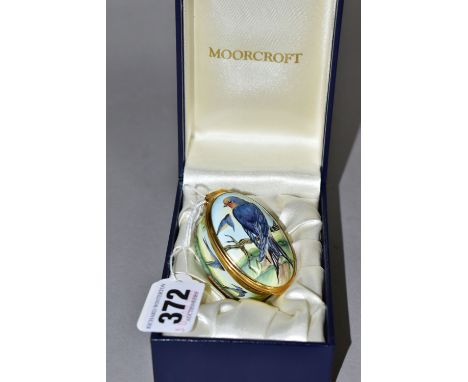 A BOXED MOORCROFT ENAMELS TRINKET BOX, of oval form, decorated in the 'Swallows' pattern, with swallow inside the hinged lid,