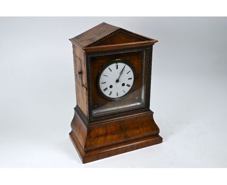 A 19th century figured walnut cased mantel clock, the 8-day two train movement with 12 cm enamelled dial, 42 cm h o/all