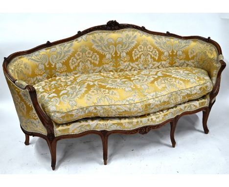 An 18th century Louis XV walnut show-framed serpentine form sofa, with traditional floral silk upholstery, raised on moulded 