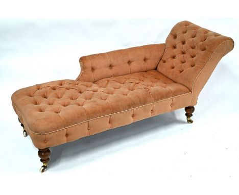 A Victorian scroll end chaise longue with faded pink buttoned upholstery, raised on turned legs on white ceramic castors 178 