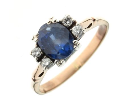 Sapphire and diamond ring, unmarked, the oval cut sapphire with pairs of brilliant cuts to either side, size L½, 2.8g gross C