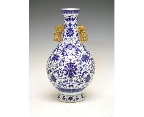 Chinese porcelain vase, of bulbous form with gilt handles and Royal blue enamel Ming-style floral decoration, under glaze blu