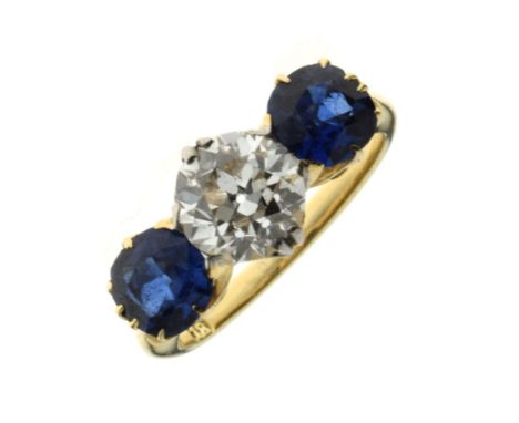 Diamond and sapphire three stone ring, the yellow mount stamped '18', the old brilliant cut of approximately 1 carat calculat