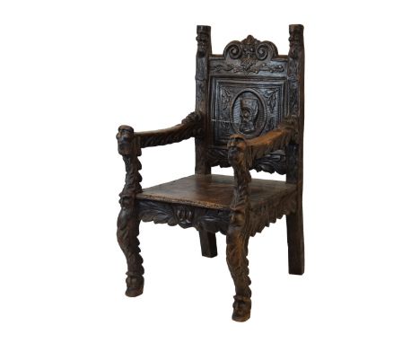 Renaissance Revival carved elm throne chair, the back headed by 'Green Man' mask between scrolls, over Romayne-style profile 