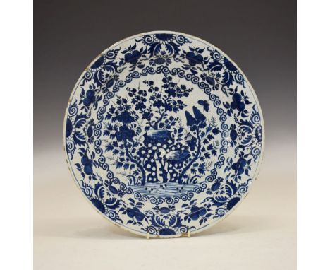 18th Century Delftware shallow dish, decorated with trees and rock work within floral borders, unmarked, 38.5cm diameter Cond