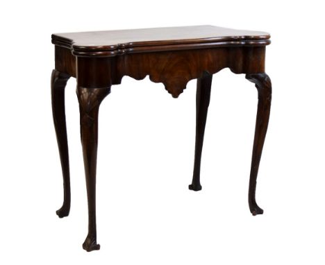 Early George III mahogany fold-over card table, of 'dog-ear' design, the hinged top enclosing corner candle stands and guinea