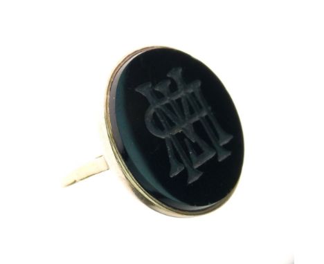 Intaglio monogram onyx signet ring, stamped '18ct', size J, 7.6g gross Condition: The circular panel approx 2cm diameter havi