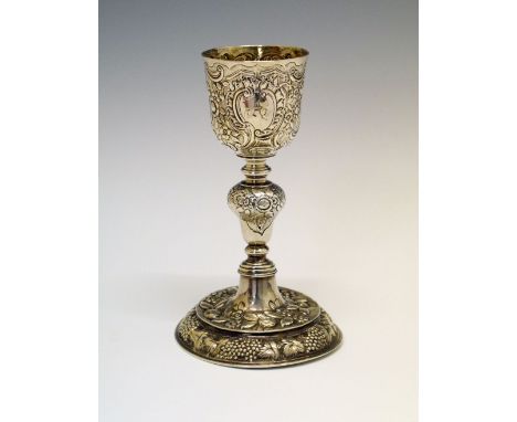19th Century white metal goblet, standing on a circular foot with later chased decoration, unmarked, 235g approx, 17.5cm high