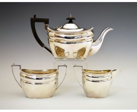 George V three-piece tea set, of shaped rectangular form with beaded border, sponsors mark possibly of Boardman Glossop &amp;