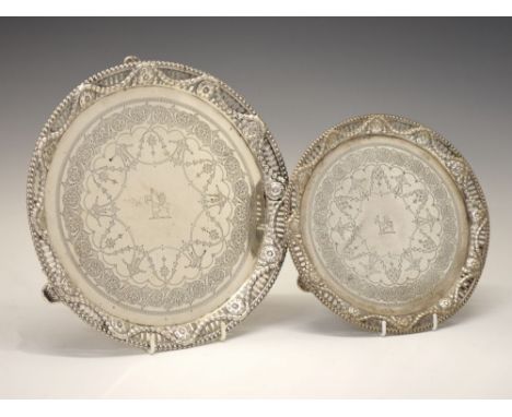 Set of two Victorian silver salvers, with engraved decoration and pierced swag borders, each standing upon three cast feet, s