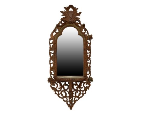 Continental carved pine or fruitwood console mirror, the plain triple-arched plate within foliate scroll carved surround with