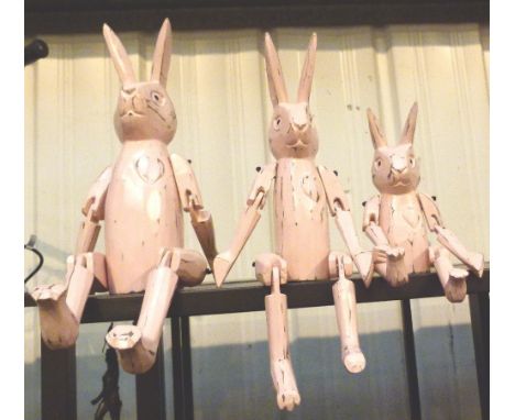 Three graduated shelf rabbits, largest H: 38 cm 