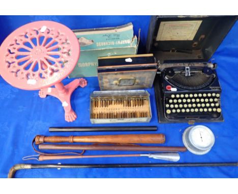 A REMINGTON PORTABLE TYPEWRITER roller poor condition, a metal money box, a box of stencils, a riding crop, a wooden truncheo