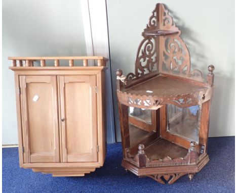 A SMALL STRIPPED PINE CUPBOARD 51cms height, together with a mirrored fretwork corner shelf, 