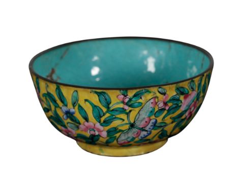 A CHINESE ENAMEL BOWL Qing dynasty or later, decorated with fruit, scrolling foliage and a butterfly on a yellow ground, with