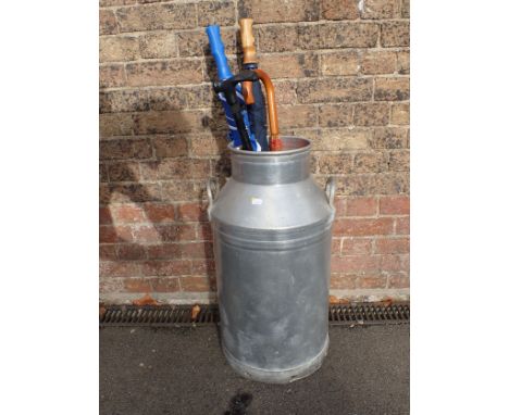 A 'DESCO' ALUMINIUM MILK CHURN 66cm high, and a few umbrellas