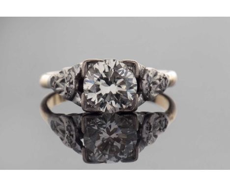 Diamond Solitaire ring, a round brilliant cut diamond of approx 1.28ct, in a box setting, and raised between small diamond se