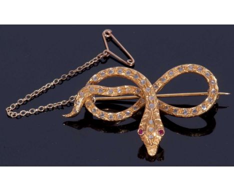 Vintage serpent brooch, the head features two red ruby eyes and three small old cut diamonds, the coiled body highlighted wit