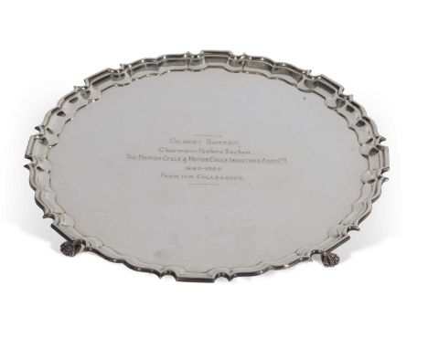 Elizabeth II shaped circular salver with 'Chippendale' edge supported on four paw feet, presentation inscription to centre da