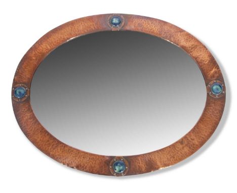 Late 19th century oval wall mirror in the Arts &amp; Crafts style, the frame with planished copper mount and applied ceramic 
