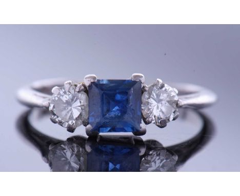 Sapphire and diamond three stone ring, centring a square cut sapphire flanked by two brilliant cut diamonds, 0.20ct wt each a