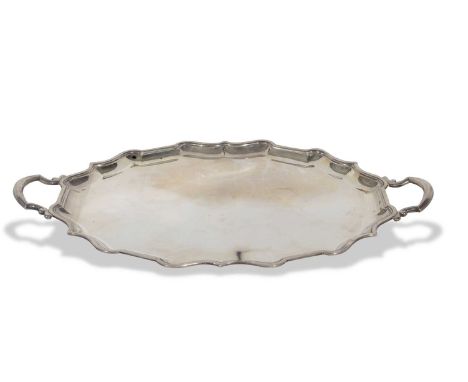 George v heavy tea tray of plain polished oval form having 'Chippendale' rim and two scrolled and loop handles, uninscribed, 