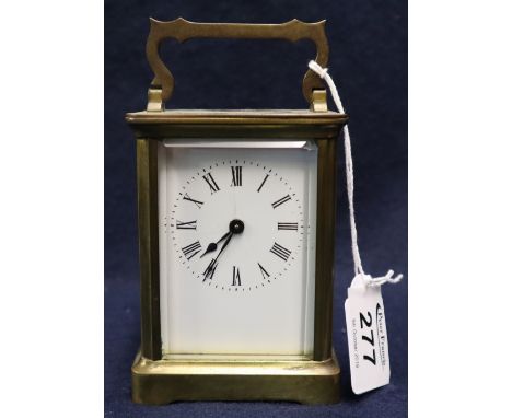 Small early 20th Century brass carriage clock with full depth Roman enamel face. 11cm high approx. (B.P. 24% incl. VAT) CONDI