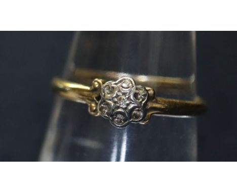 An 18ct gold and diamond flower head ring. 1.5g approx. (B.P. 24% incl. VAT)