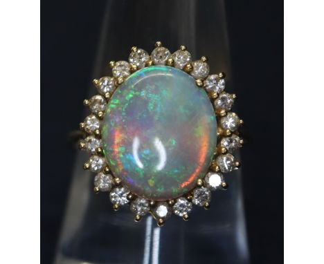 An 18ct gold opal and diamond dress ring. 5.8g approx. (B.P. 24% incl. VAT) CONDITION REPORT: Ring size M. Opal approximately