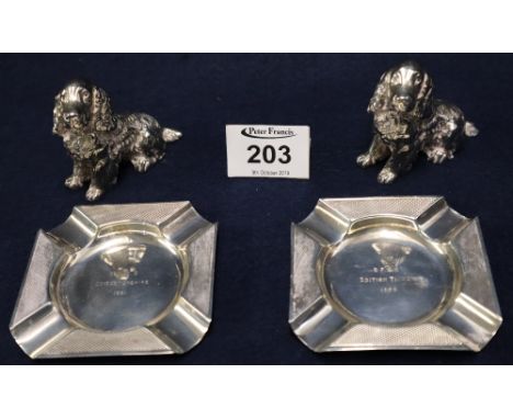 Pair of silver engine turned ashtrays with presentation inscriptions, together with a pair of cast white metal figures of sea