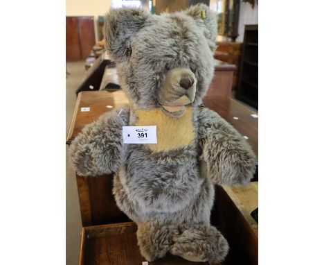 Large Steiff teddy bear with silver button to ear, having stitched nose, movable limbs and padded arms and feet. (B.P. 24% in