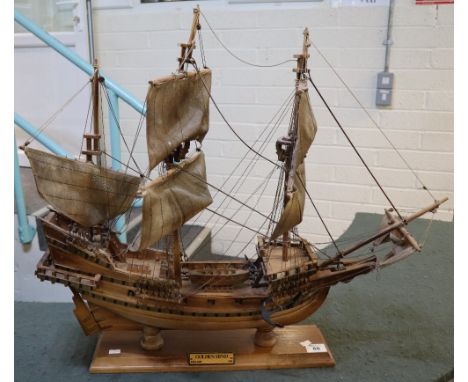 Wooden model of the 'Golden Hind' a 16th Century three masted sailing ship, with detailed rigging on wooden base. (B.P. 24% i