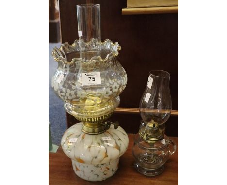 Early 20th Century brass double burner oil lamp with marbled glass reservoir, flower head decorated shade and clear chimney. 
