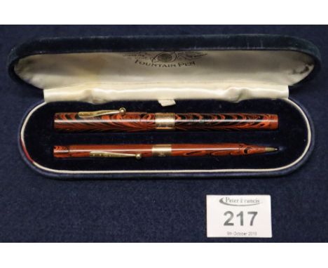 A Waterman's Ideal fountain pen and propelling pencil set, with marbled cases, both having engraved 9ct gold collars, dated 1