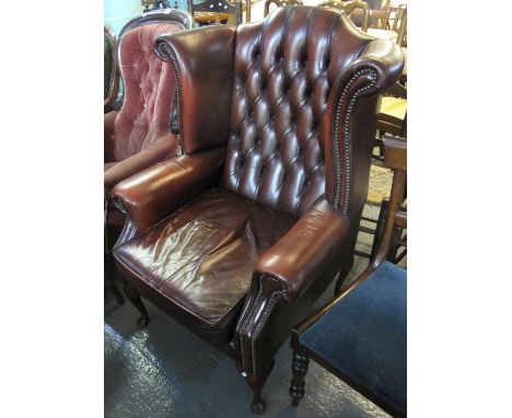 Chesterfield style button back oxblood wing armchair, 20th Century.(B.P. 24% incl. VAT)