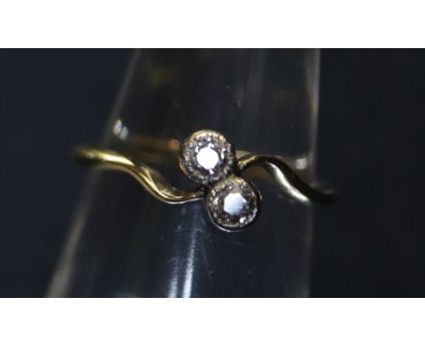 A yellow metal two stone on a twist diamond ring, 1.9g approx. (B.P. 24% incl. VAT)