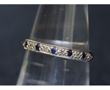 An 18ct white gold and diamond and sapphire half eternity style ring. 2.3g approx. (B.P. 24% incl. VAT)