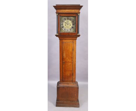 An oak eight day longcase clock, early 18th century, with moulded cornice above twin brass mounted columns, the plain trunk o