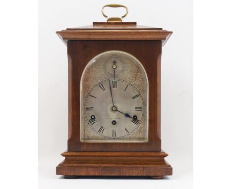An Edwardian oak bracket clock,  the arched silvered dial with Roman numerals and subsidiary Chime/Silent dial, the German mo